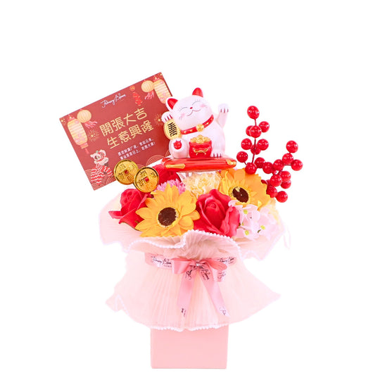 Floral arrangement with a fortune cat and grand opening card on a white background